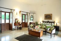 Bedroom with writing desk and armchairs