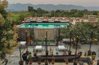 Pool terrace and dining courtyard below the Aravalli hills