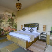 Bedroom with painted tiger mural and antique door headboard