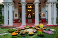 Assamese meal laid on banana leaf outside the portico