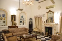 Drawing room with marble fireplace and chequered floor