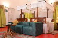 Bedroom with two carved wooden four poster beds