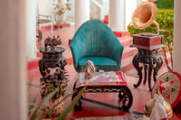 Verandah corner with gramophone and carved stands