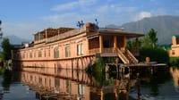 The houseboat moored on Dal Lake below the mountains