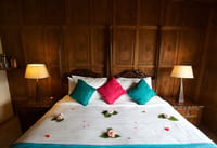 Bed against a carved walnut panelled wall