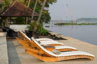 Lakefront terrace loungers facing Chinese fishing nets