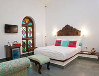 Bedroom with arched stained glass window