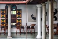 Colonnaded verandah restaurant with stained glass shutters