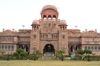 Palace entrance front with carved central dome, chhatris and topiary drive