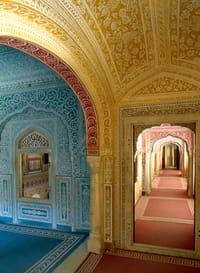 Painted archway opening onto the turquoise swimming pool