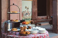 Tiered afternoon tea stand against painted wall