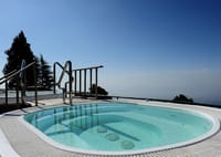 Outdoor hot tub on deck above the valley