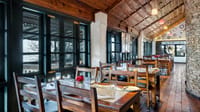 Restaurant interior with wood ceiling and long tables