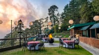Lawn dining tables with lanterns at dusk