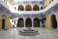 Inner courtyard with marble fountain and yellow arcades