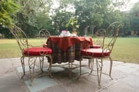Private dining table laid out on the garden lawn