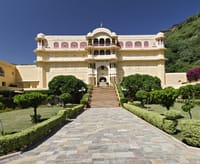 Palace facade above formal garden and driveway