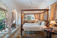 Four-poster bed in room with chequered floor