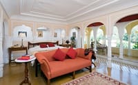 Suite sitting area with orange sofa beside arcade