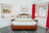 Deluxe room with carved wooden bed