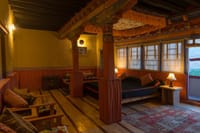 Heritage Suite with painted canopy columns, window seating and views over the Indus Valley at Stok Palace Heritage, Leh