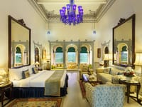 Royal Suite with blue chandelier and tall mirrors