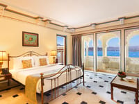 Terrace Suite with arched windows over the lake