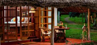 Cottage verandah with cane table beside the garden