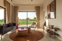 Cottage living room with jute rug and picture window onto the fields