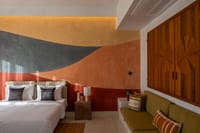 Cottage bedroom with desert-toned mural wall and daybed