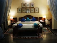 Bedroom with botanical prints above the bed