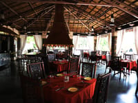 Thatched restaurant interior with a central hearth
