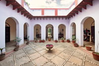 Arcaded inner courtyard of the Mela Kothi with stone-paved floor