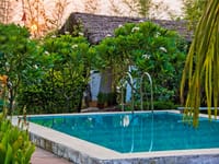 The pool at Tigergarh, ringed by frangipani and forest