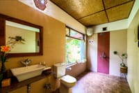 A cottage bathroom with a window onto the garden
