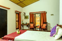 A cottage bedroom with the garden through the window