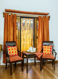 The sitting corner of a cottage, looking onto bamboo
