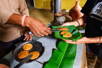 Fresh bread off the pan, served on a banana leaf