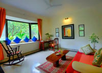 A suite with a bay window and a rocking chair