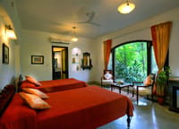 A bedroom with the garden through the window