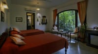 A suite bedroom with the forest through the window