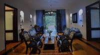 The sitting room of a suite, opening to the garden