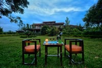 A table set on the lawn, the lodge behind
