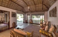 A thatched suite with wooden flooring and garden access