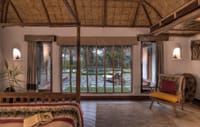 A thatched villa bedroom looking at the river