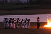A tribal fire dance on the riverbank