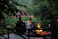 Dinner on a wooden deck beside a bonfire