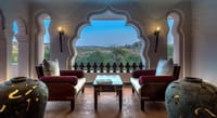 A suite living area with arched windows
