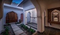 A whitewashed courtyard with arched doorways