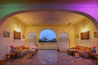 A sitting area under an arch, open to the garden